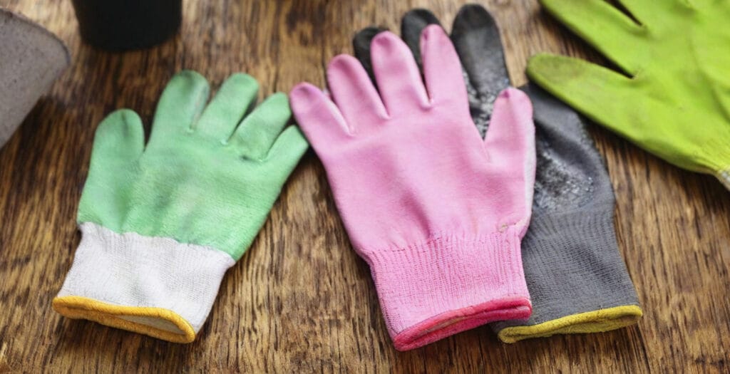 4 gardening gloves on a table