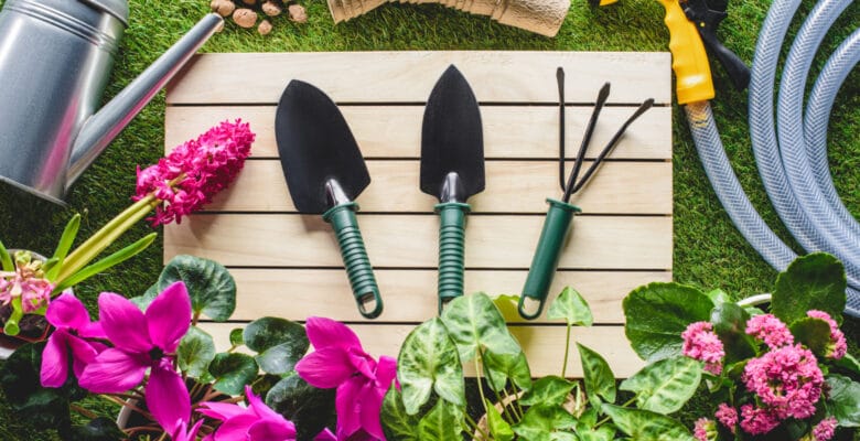 garden hand tools on a table surrounded by plants, the best garden hand tools